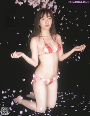 A woman in a red and white bikini posing for a magazine.