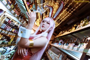 A woman sitting on a couch wearing a bunny costume.