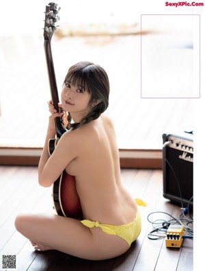 A woman in a bikini laying on the floor.