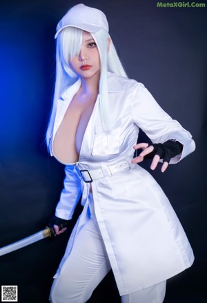 A woman in a white outfit is posing for a picture.