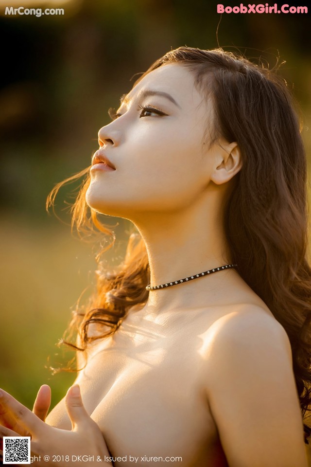 A woman in a red dress is posing for the camera.