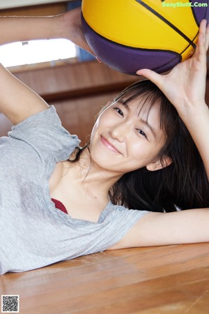 A woman in a blue bra and panties laying on a bed.