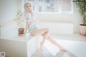 A woman sitting on a chair in a room.