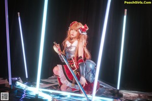 A woman in a red and white outfit holding a sword.