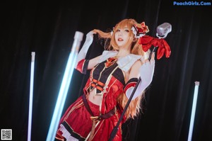 A woman in a red and white outfit holding a sword.