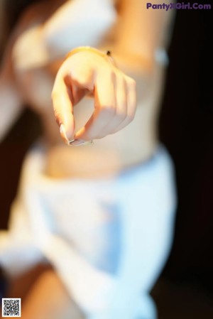 A woman in a blue and white outfit standing in front of a mirror.