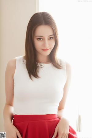 A woman in a red lingerie posing for the camera.