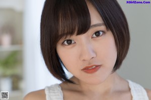 A woman in a white dress posing for a picture.
