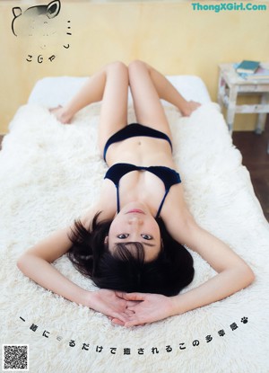 A woman in a bikini posing for a magazine cover.