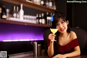 A woman in a red dress sitting at a bar.