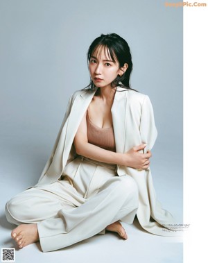 A magazine with a picture of a woman in a white sweater.